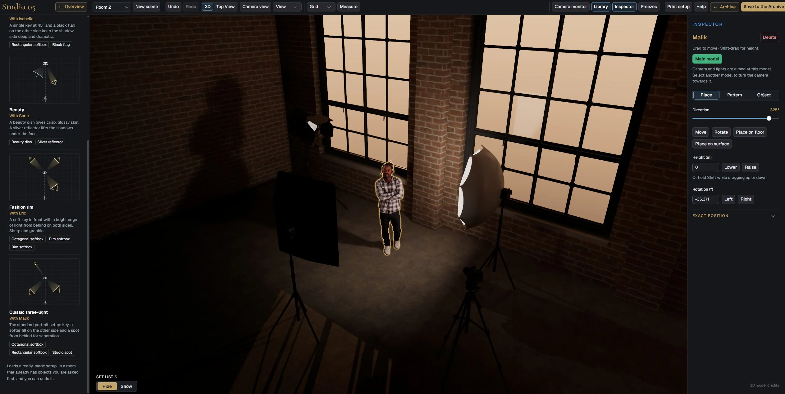 Studio 5 Set Builder with Malik standing between two lights in a brick loft with large warm windows